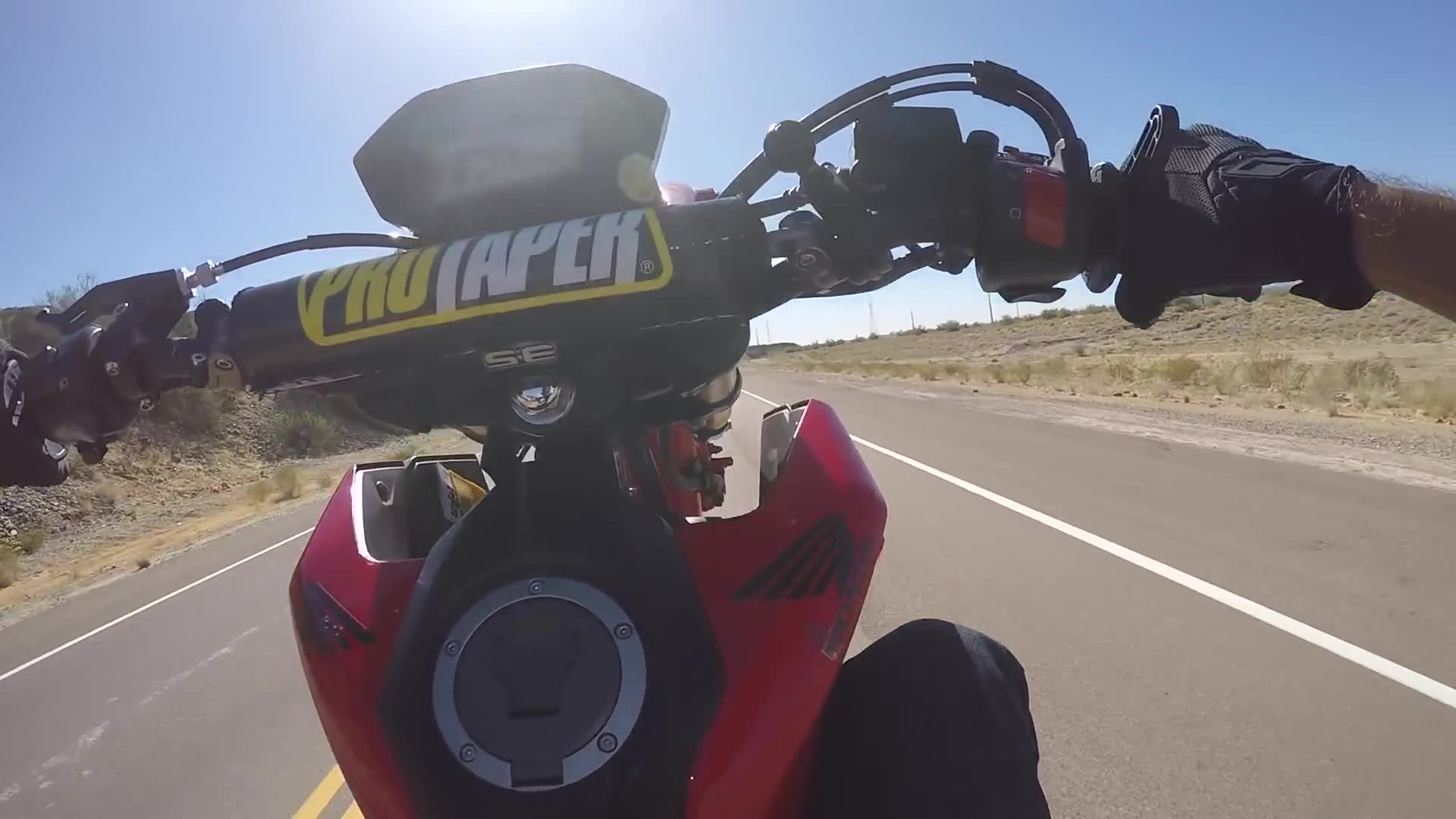 Girlfriend learns to lift front wheel on motorcycle for first time
