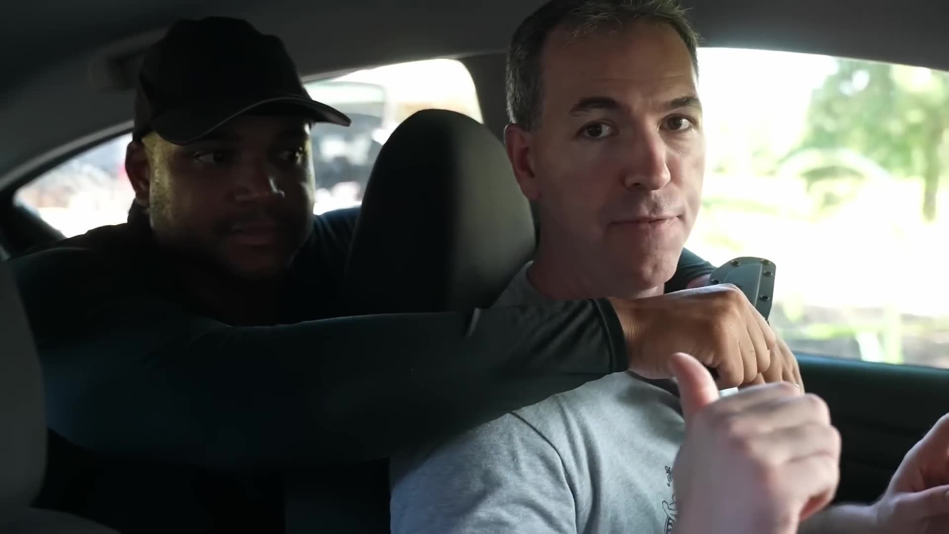 Defense tactics when discovering armed person hiding in vehicle rear seat