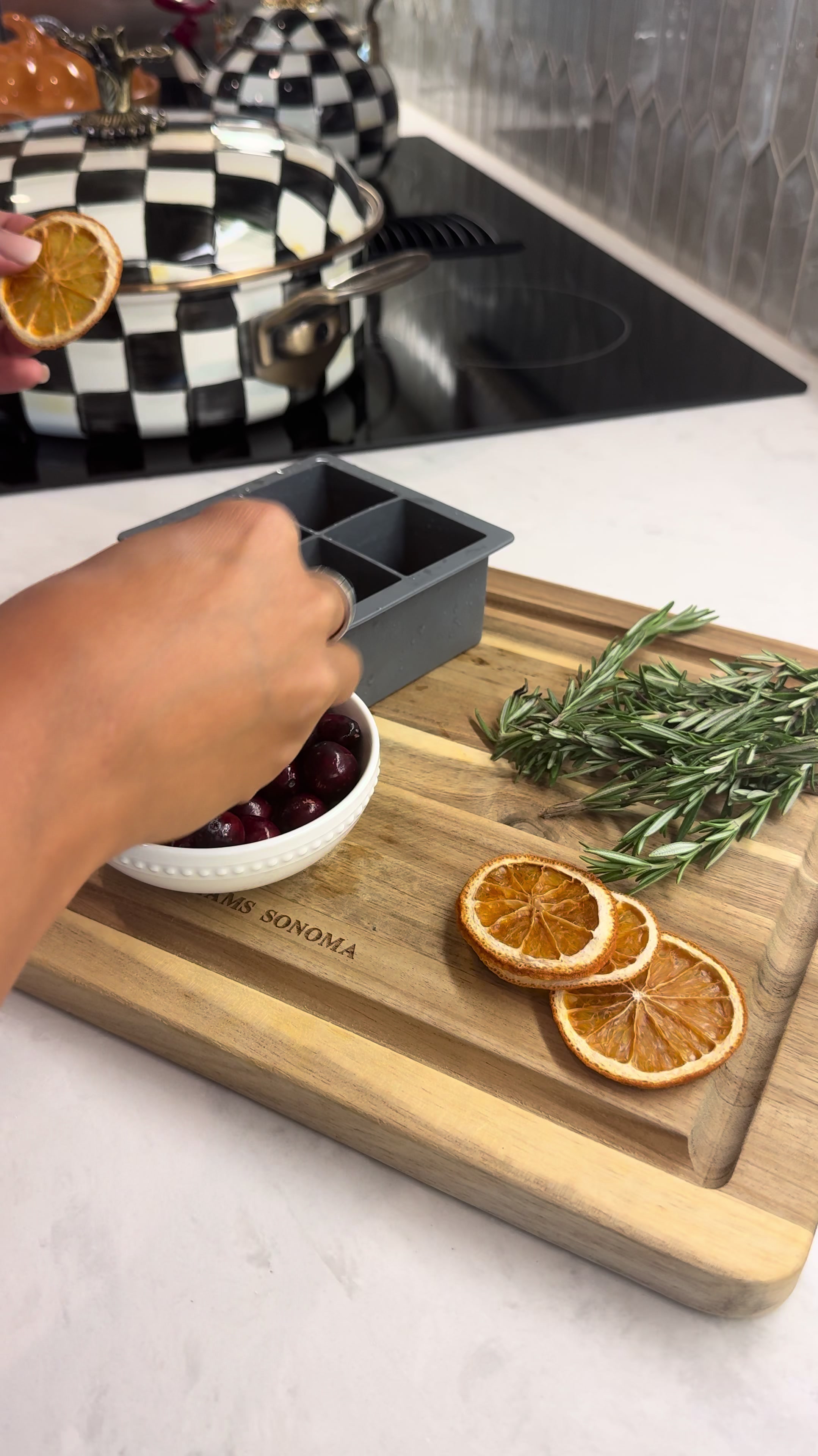 Infused ice cubes for evening cocktails with dried orange rosemary dark cherries making