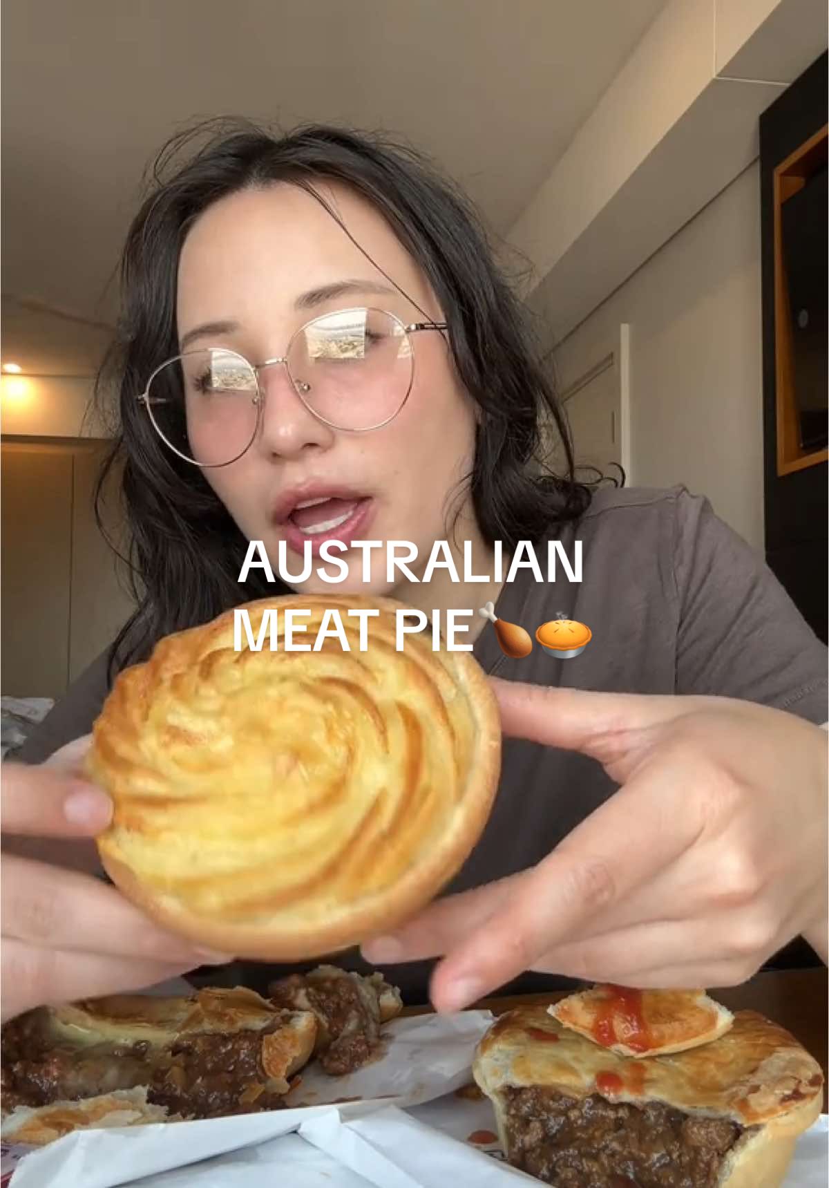 Trying steak, onion, potato, and bacon pies with sauce in Australia