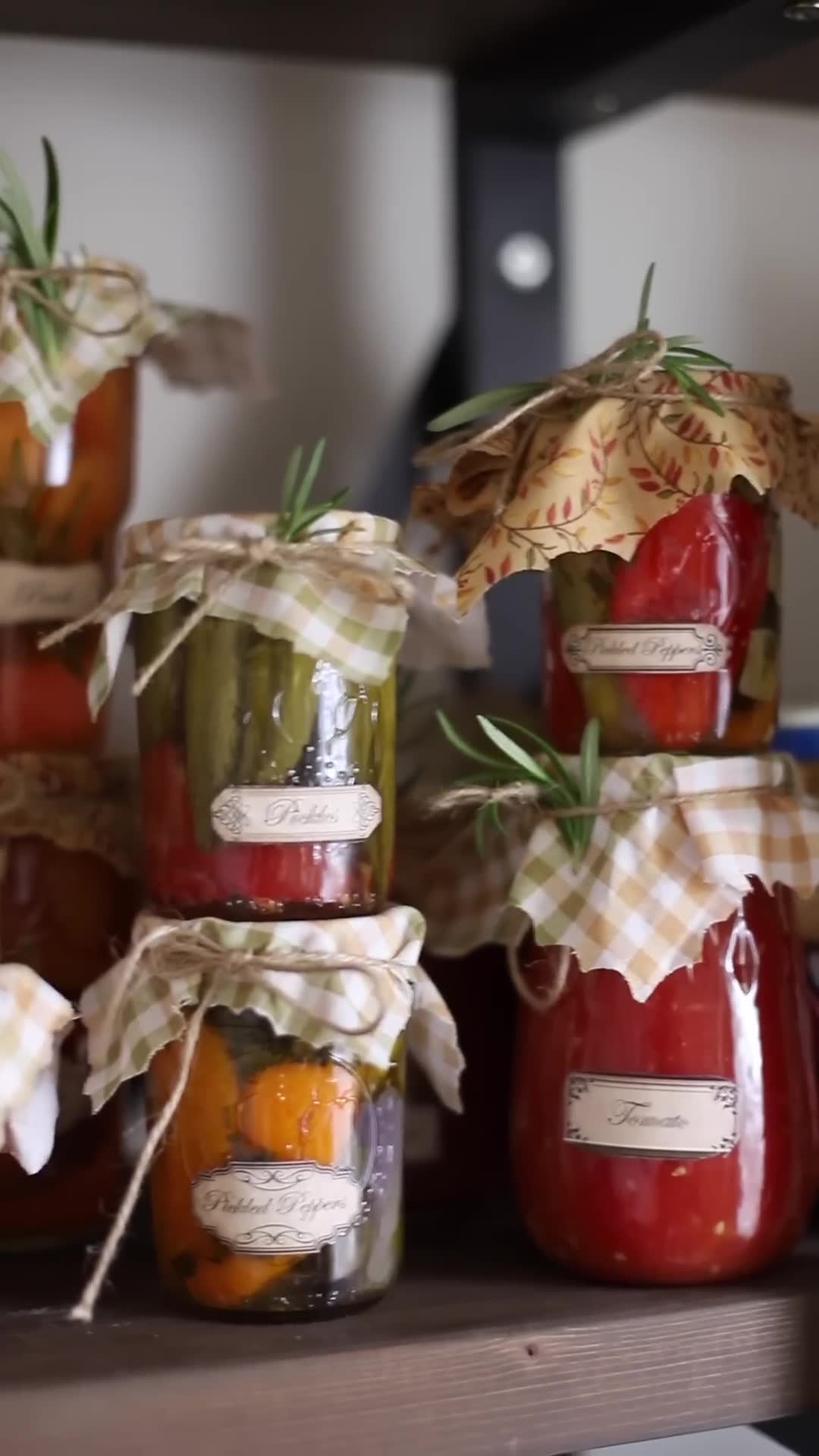 Home preservation featuring pickled vegetables and canned peppers
