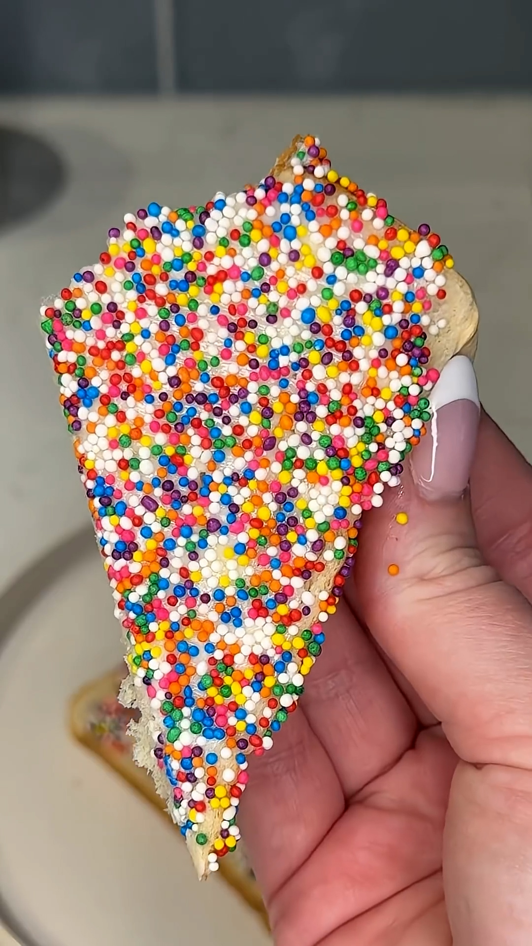 Buttered bread topped with colorful jimmies for simple dessert
