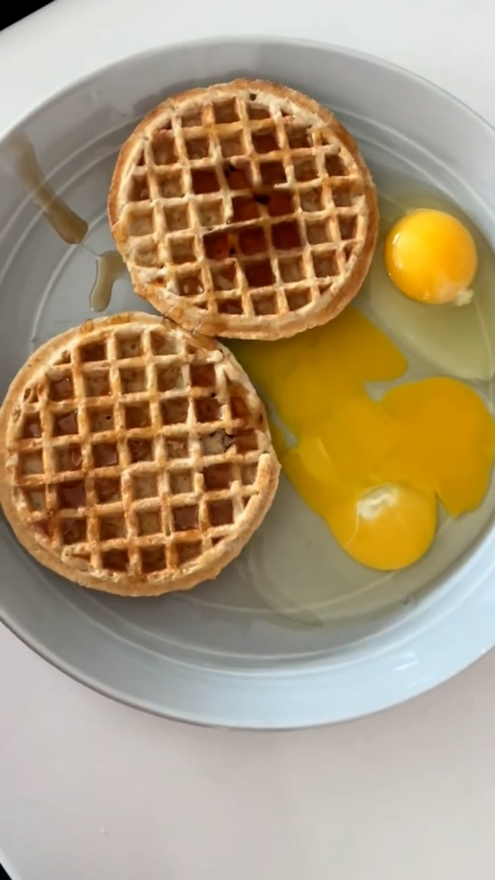 Breakfast prank with raw eggs and frozen waffles served together