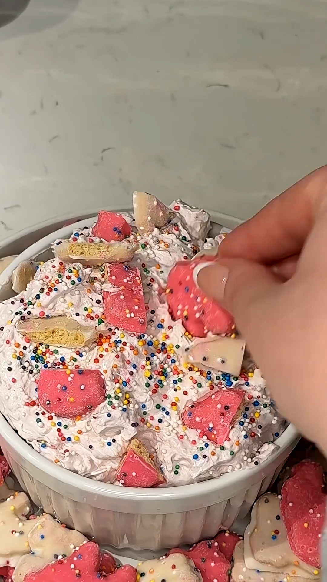 Frosted animal cookies blended into a sweet pink party dessert dip