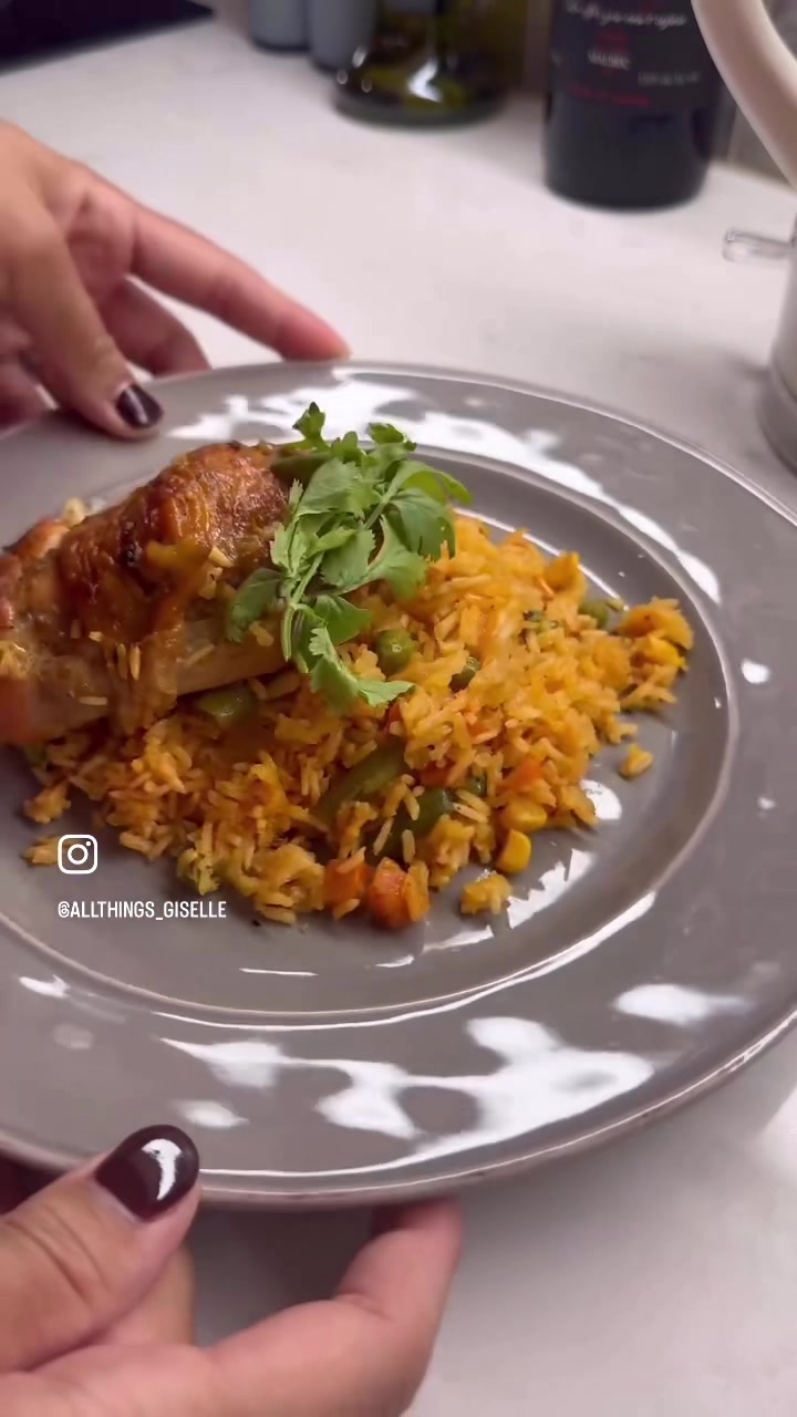 A comforting dinner of golden roasted chicken and colorful Mexican vegetable rice