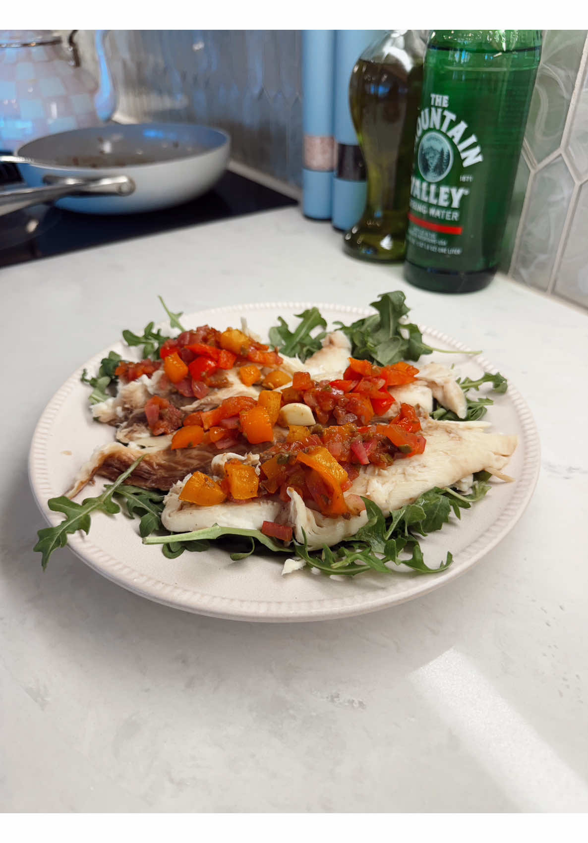 Making light pan cooked fish fillets with bright bell pepper salsa and peppery arugula