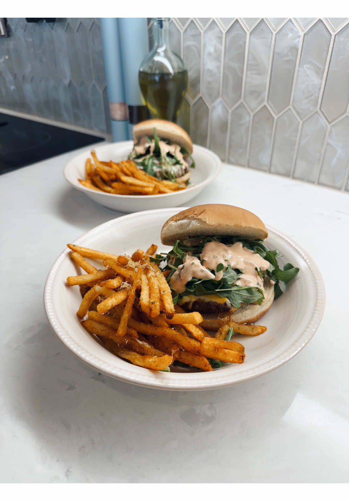 Making a juicy homemade cheeseburger with seasoned fries and a creamy special sauce