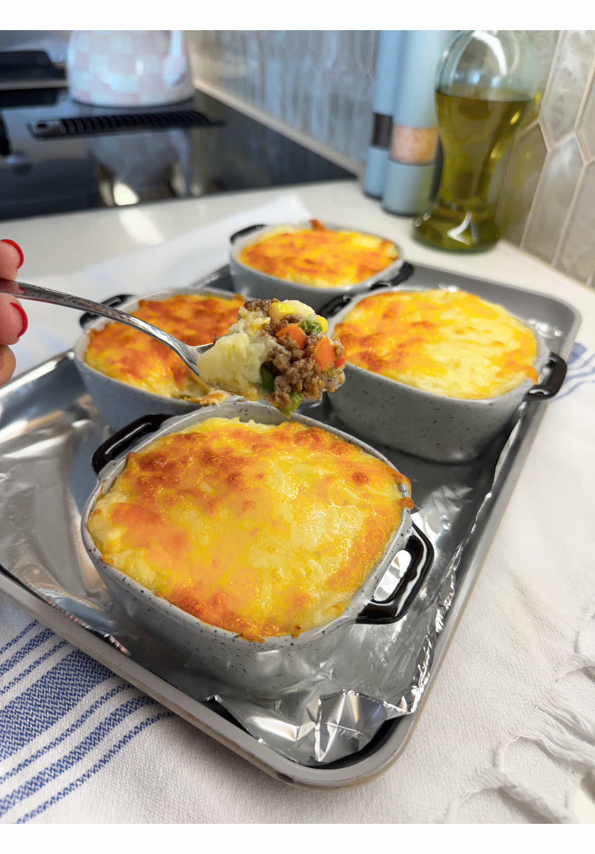 Making cozy individual shepherd's pies crowned with creamy golden mashed potatoes