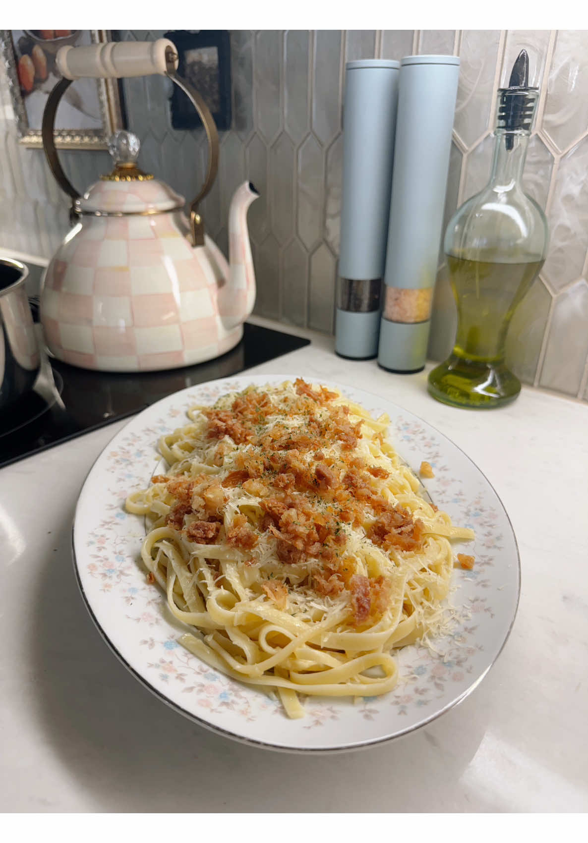 Making rich creamy linguine topped with crispy bacon and parmesan for a shared meal