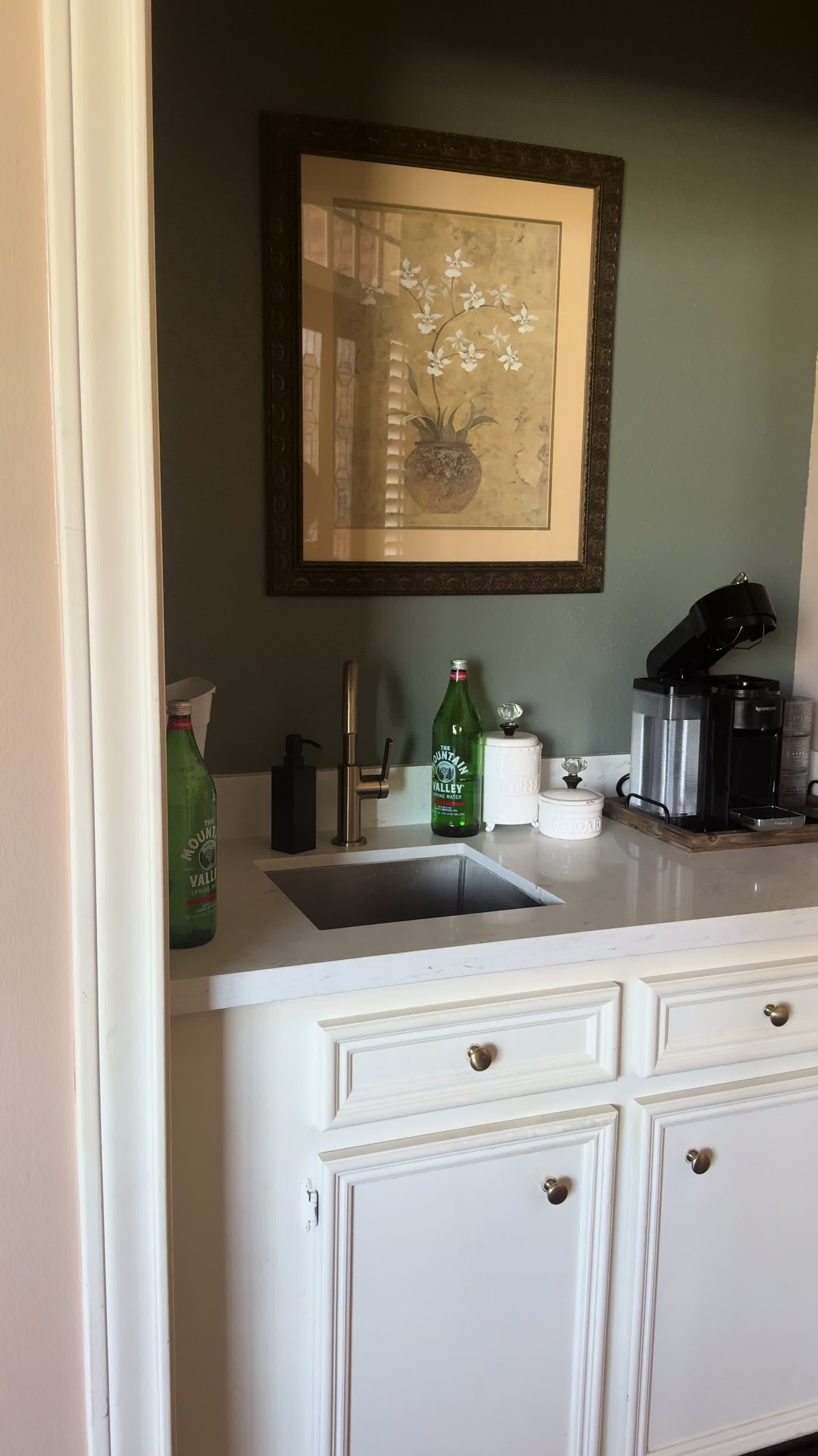 Showing off the party ready wet bar and coffee station with Nespresso and Mountain Valley