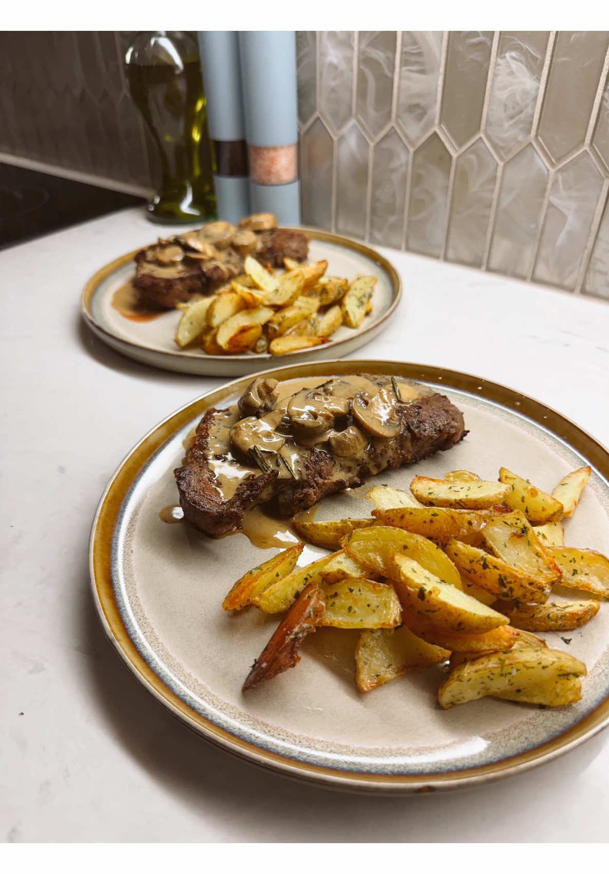 Making creamy mushroom steak and herb roasted potato wedges for a date night in
