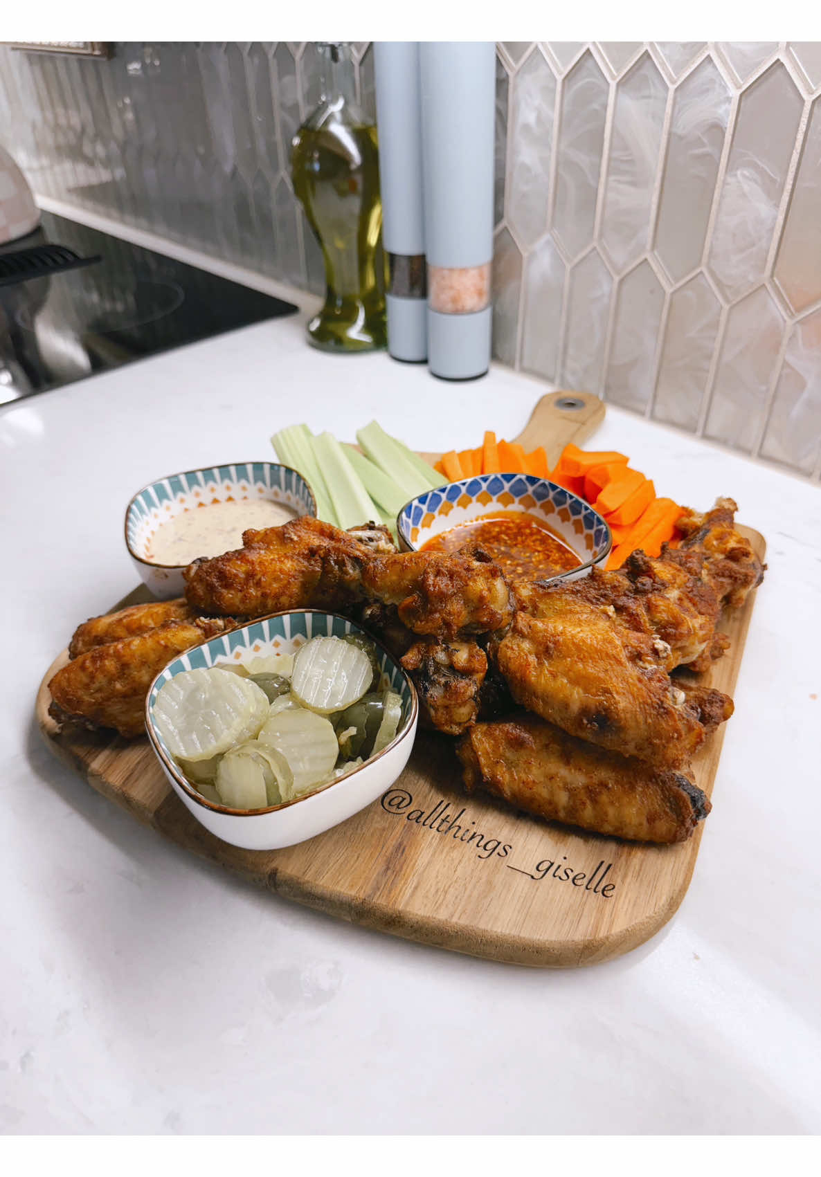Making golden fried chicken wings served with cool dips and crunchy fresh vegetables