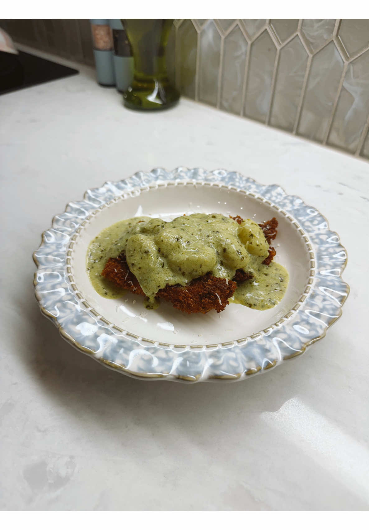 Making a crispy breaded cutlet with creamy herb sauce over soft gnocchi for dinner
