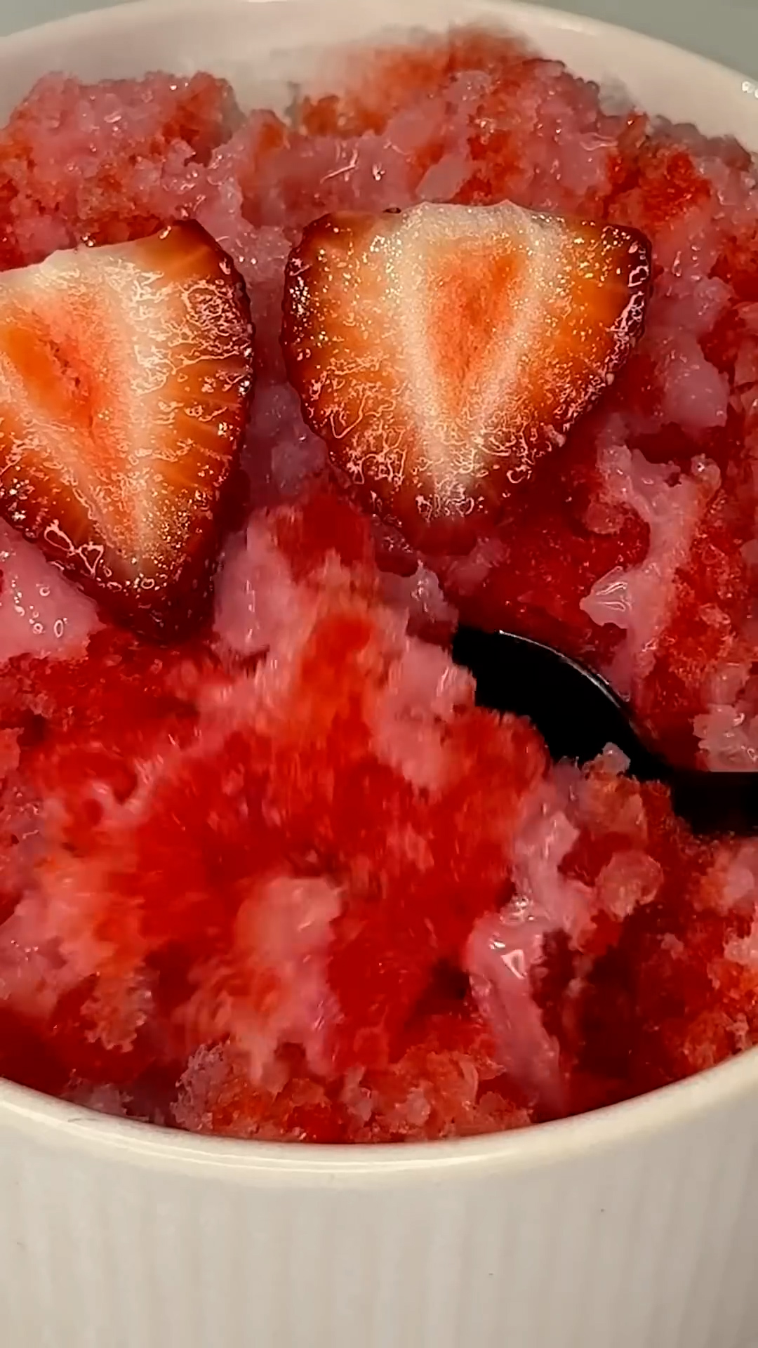Fluffy shaved ice drizzled with bright strawberry for a cool treat
