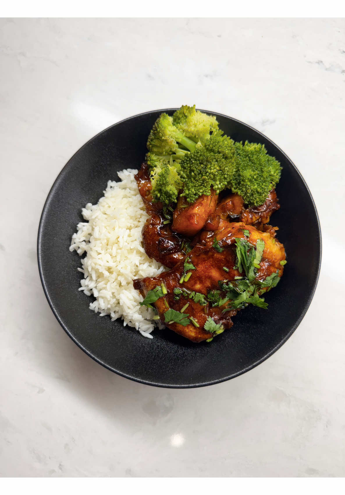 Making sweet pineapple teriyaki chicken served with fluffy rice and green broccoli