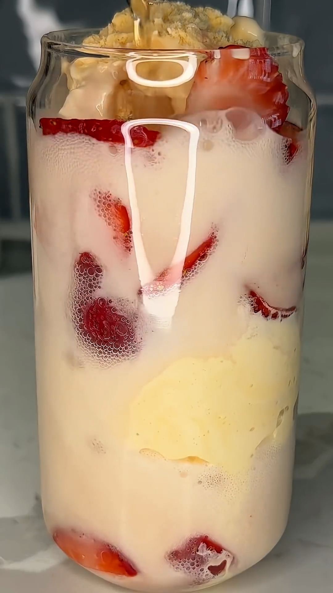 Scoops of ice cream fizz up in strawberry soda for a classic float