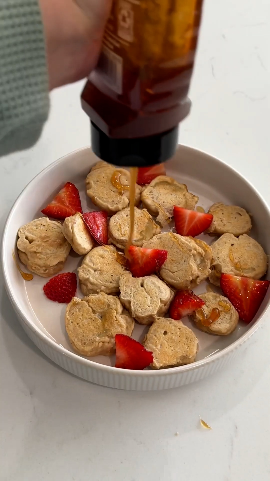 Tiny banana pancakes stacked up for a cute and easy breakfast plate