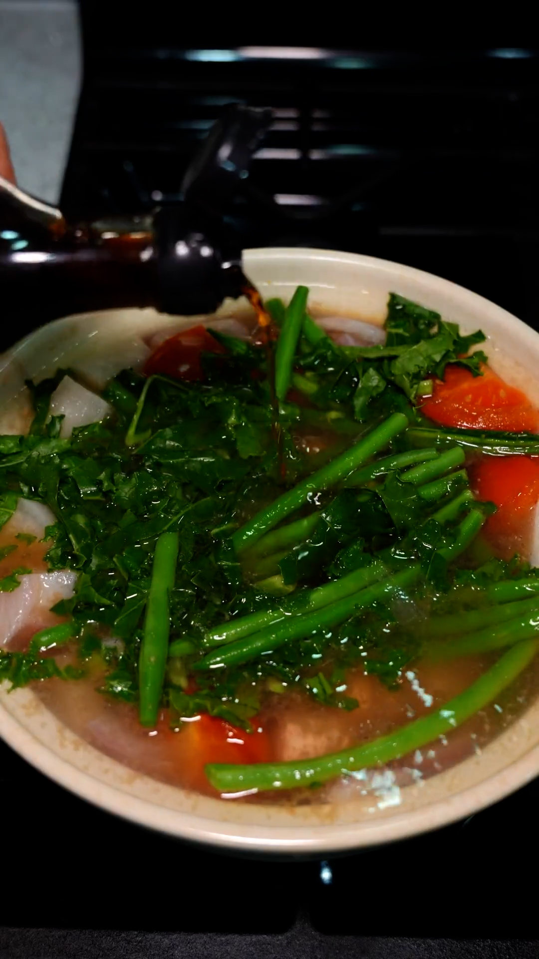 Traditional Filipino sinigang with the perfect balance of sour and savory